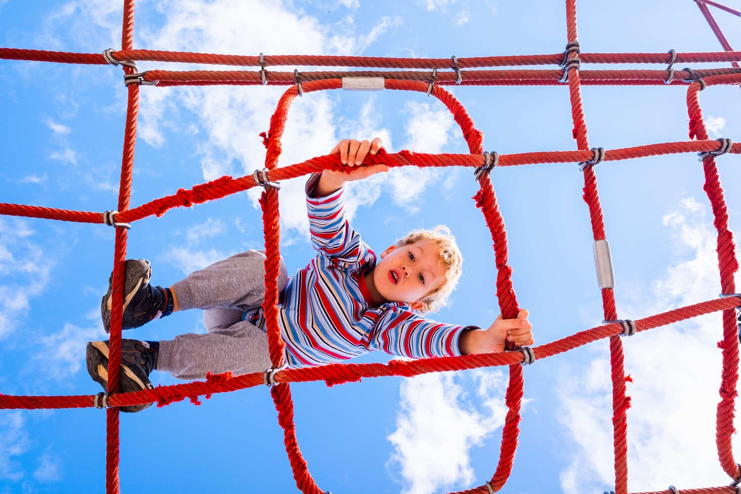 directly_shot_boy_playing_jungle_gym_against_sky.jpg